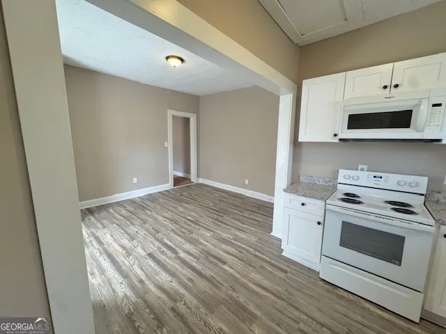 a kitchen with a stove and a microwave