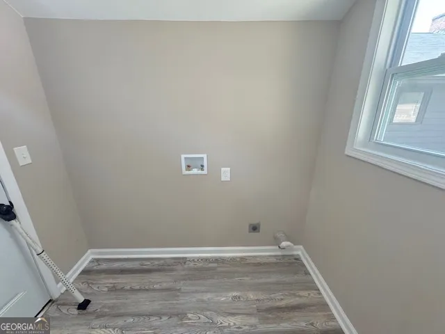 a view of room with window and hardwood floor