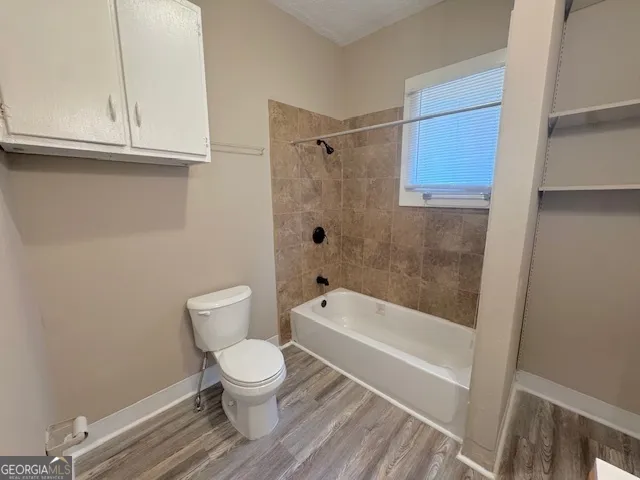 a bathroom with a toilet and a bathtub