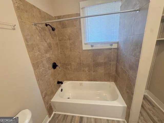 a bathroom with a tub and a shower