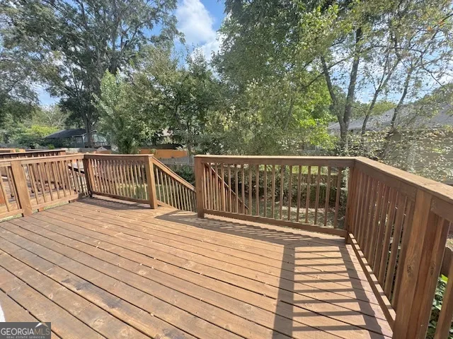 a balcony with wooden floor and fence