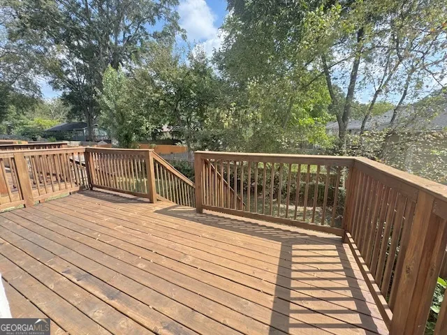 a balcony with wooden floor and fence