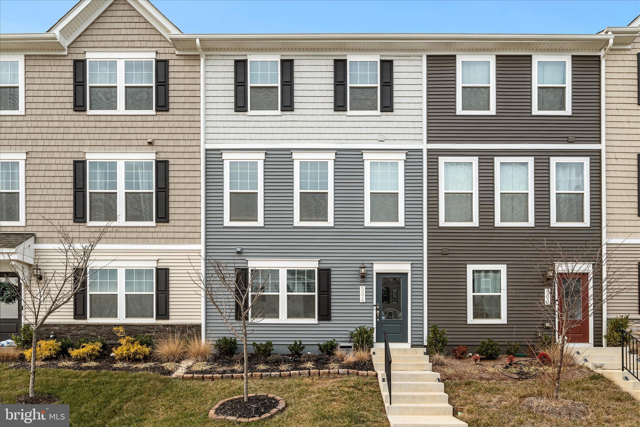 504 National Street Ranson, WV 25438 - Photo 2 of 33 a front view of a residential apartment building with glass windows and yard
