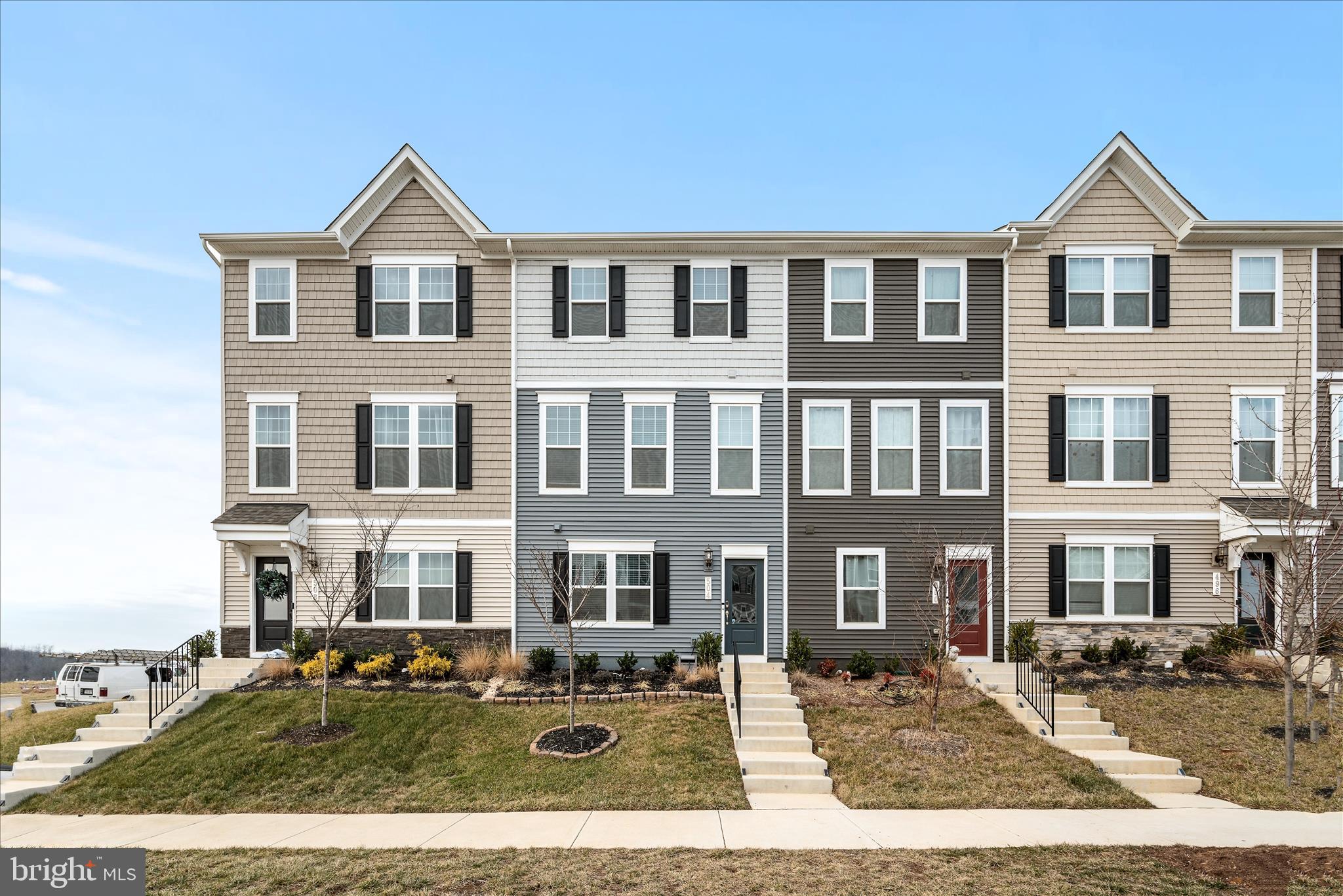 504 National Street Ranson, WV 25438 - Photo 32 of 33 a view of a white house with large windows next to a yard