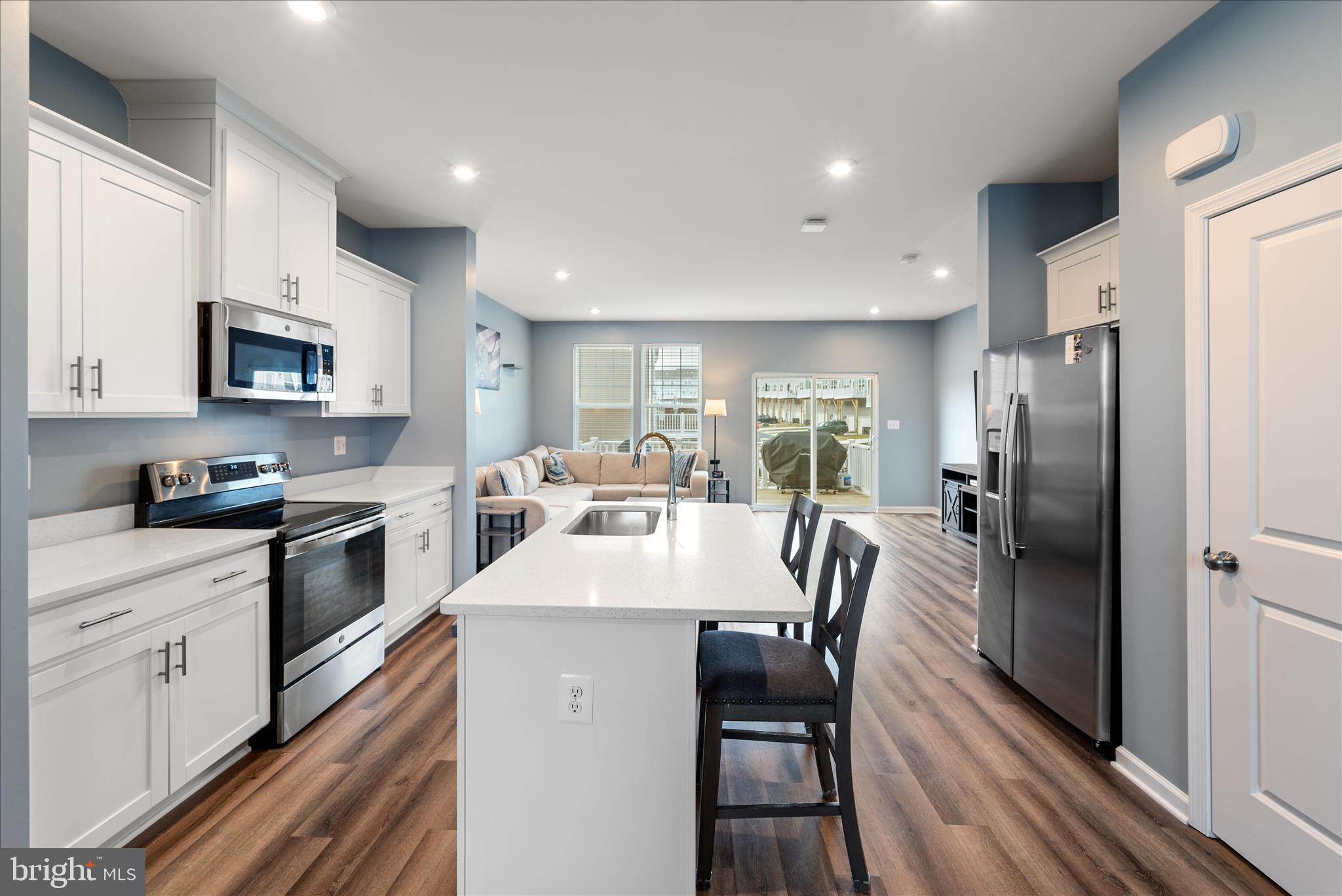 504 National Street Ranson, WV 25438 - Photo 8 of 33 a large kitchen with stainless steel appliances kitchen island granite countertop a table chairs refrigerator and a stove top oven