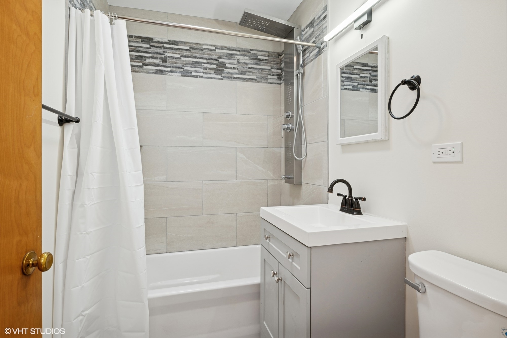 419 June Terrace Barrington, IL 60010 - Photo 11 of 18 a bathroom with a sink a toilet and shower