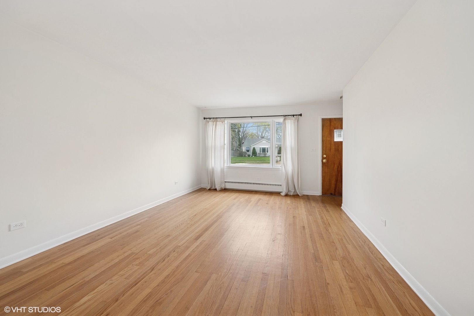 419 June Terrace Barrington, IL 60010 - Photo 2 of 18 an empty room with wooden floor and windows