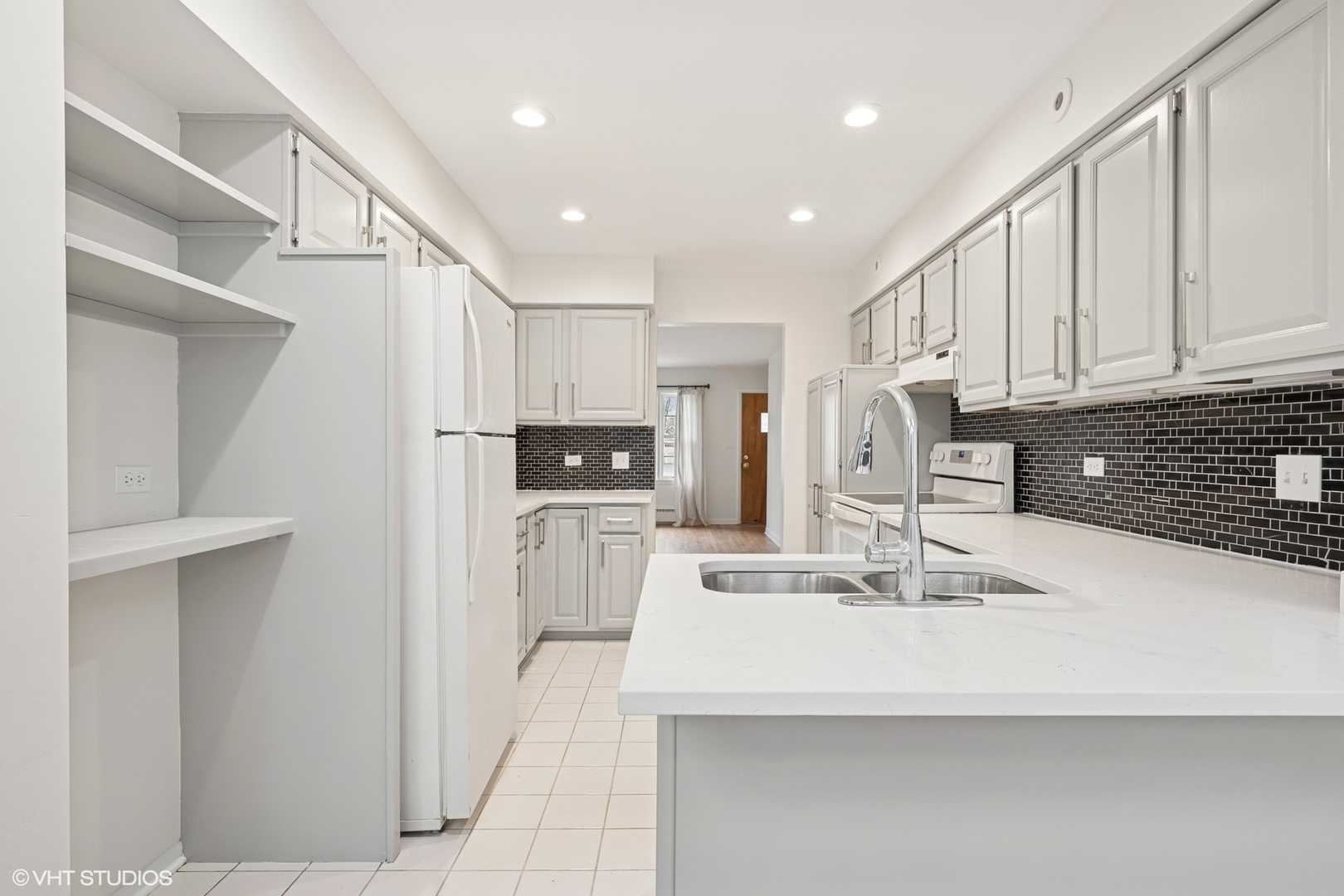 419 June Terrace Barrington, IL 60010 - Photo 4 of 18 a kitchen with stainless steel appliances kitchen island sink refrigerator and cabinets
