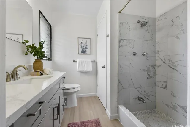 a bedroom with a bed and a potted plant