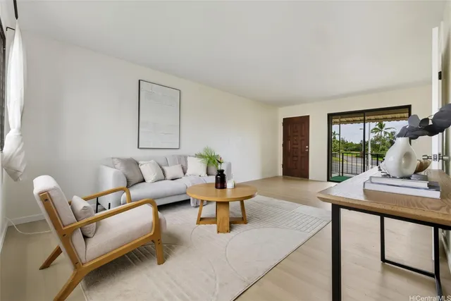 a living room with furniture and a large window