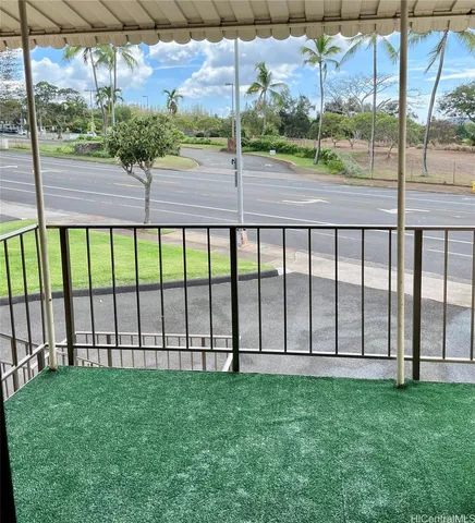 a view of a yard with a street from a window