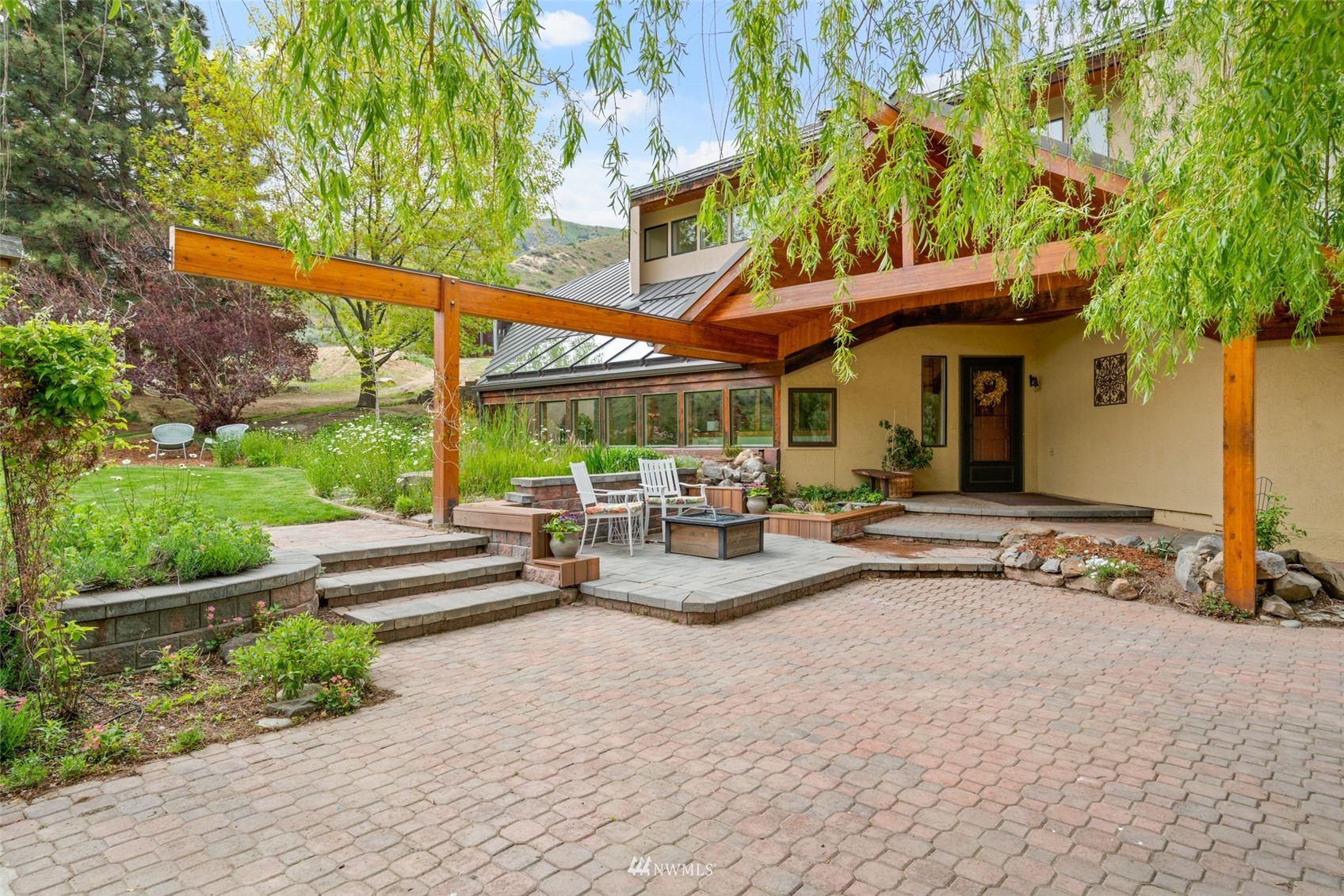 1666 Pitcher Canyon Road Wenatchee, WA 98801 - Photo 8 of 37 a view of a patio with a table and chairs under an umbrella