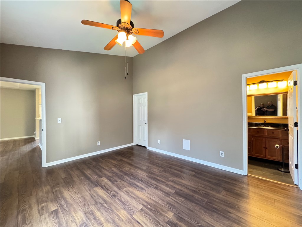 160 Wexford Drive, Unit 206 Anderson, SC 29621 - Photo 20 of 31 Vacant pic. A spacious bedroom features LVP flooring and a classic ceiling fan, offering a comfortable retreat.
