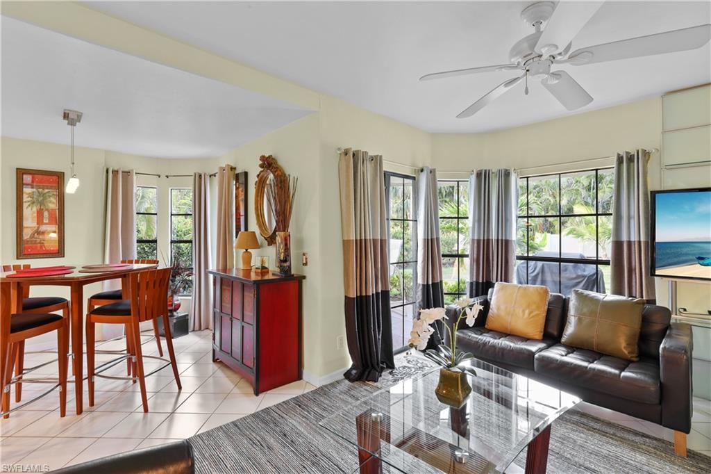 2708 Santa Cruz Boulevard Naples, FL 34112 - Photo 17 of 38 a living room with furniture a wooden floor and a window