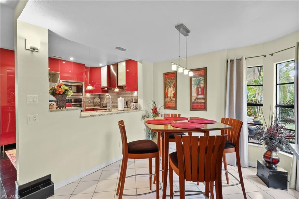 2708 Santa Cruz Boulevard Naples, FL 34112 - Photo 18 of 38 a dining room with furniture a chandelier and window