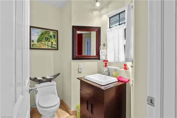 a kitchen with stainless steel appliances kitchen island granite countertop a sink stove and refrigerator