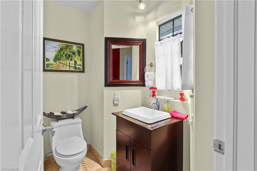 2708 Santa Cruz Boulevard Naples, FL 34112 - Photo 20 of 38 a bathroom with a toilet sink and mirror