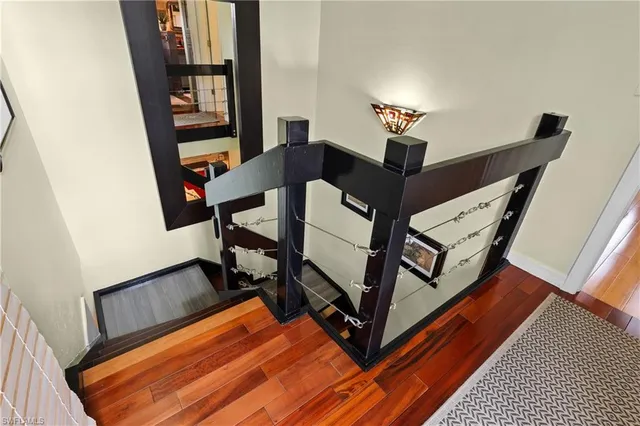 a bedroom with a bed a dresser and with potted plants