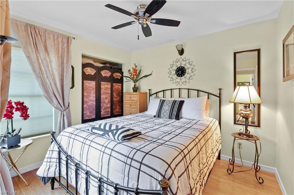 2708 Santa Cruz Boulevard Naples, FL 34112 - Photo 25 of 38 a bedroom with a bed and a chandelier