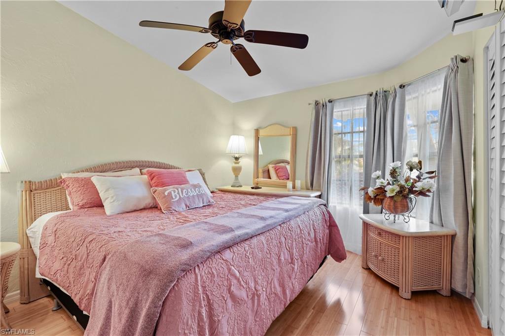 2708 Santa Cruz Boulevard Naples, FL 34112 - Photo 26 of 38 a bedroom with a bed a dresser and with potted plants