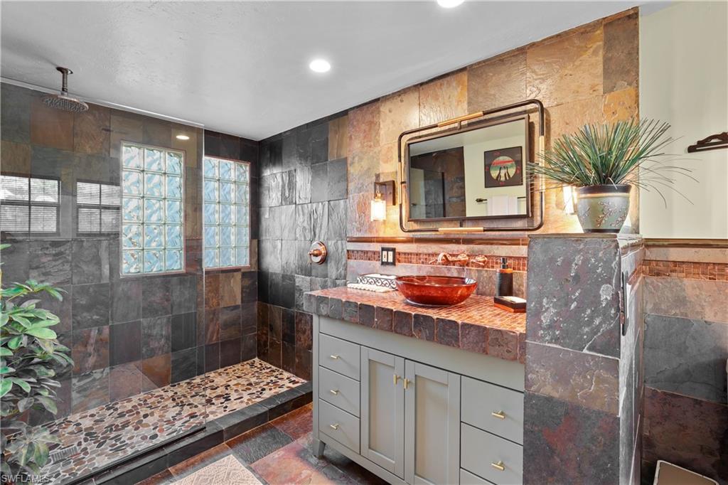 2708 Santa Cruz Boulevard Naples, FL 34112 - Photo 27 of 38 a bathroom with a sink a potted plant and a shower