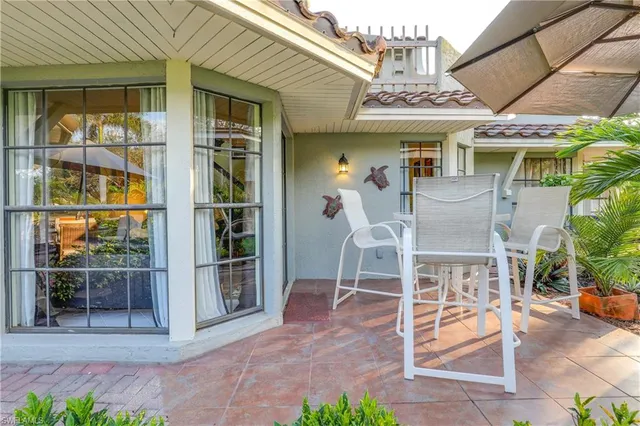 a view of a house with a yard and sitting area