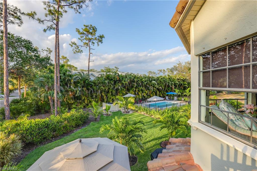 2708 Santa Cruz Boulevard Naples, FL 34112 - Photo 4 of 38 a backyard of a house with a garden and outdoor seating