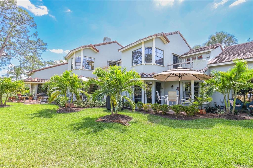 2708 Santa Cruz Boulevard Naples, FL 34112 - Photo 8 of 38 a front view of a house with a yard