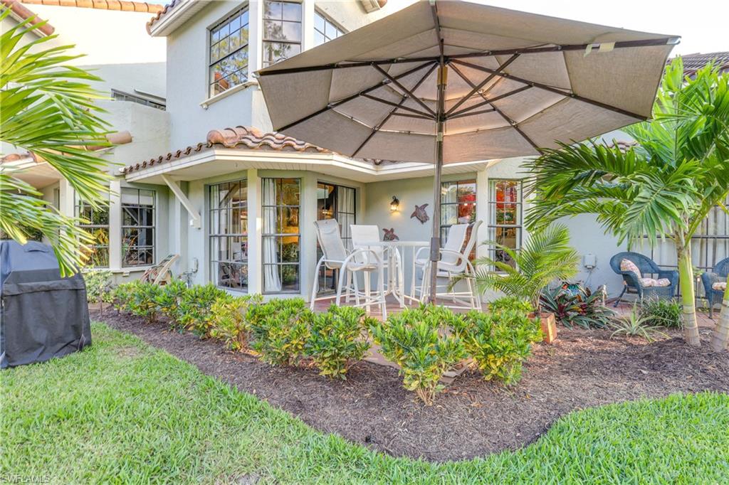 2708 Santa Cruz Boulevard Naples, FL 34112 - Photo 9 of 38 a front view of a house with garden