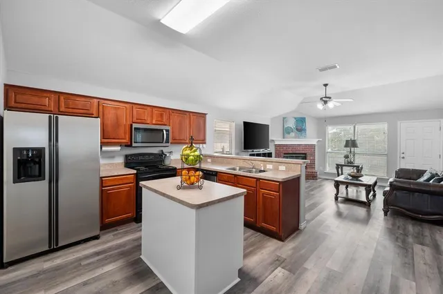 a kitchen with a sink stove and refrigerator