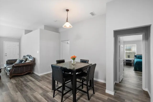 a view of a dining room with furniture and wooden floor