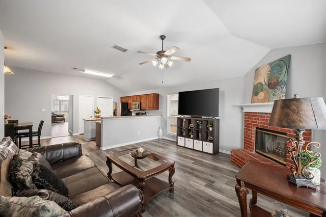 a living room with furniture a flat screen tv and a fireplace