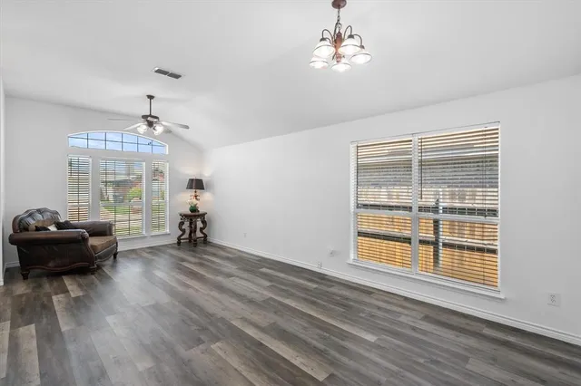 a view of a livingroom with furniture wooden floor and a window