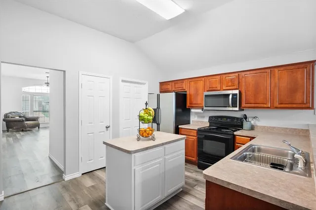 a kitchen with a sink stove and refrigerator