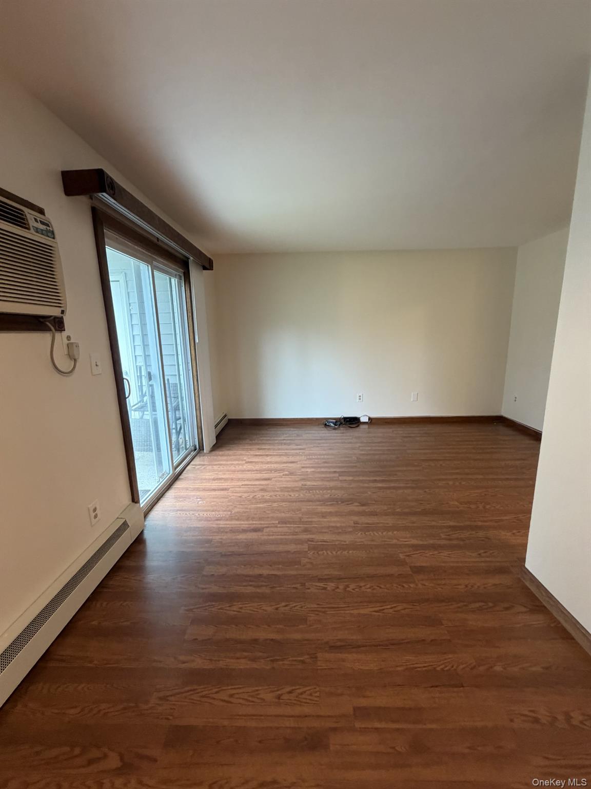 7 Ivy Court, Unit B Fishkill, NY 12524 - Photo 13 of 15 an empty room with wooden floor and windows
