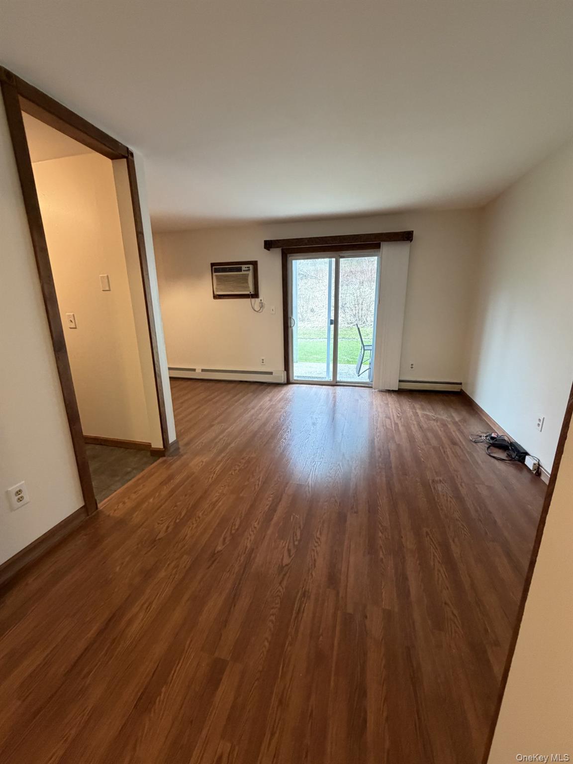 7 Ivy Court, Unit B Fishkill, NY 12524 - Photo 14 of 15 an empty room with wooden floor and windows