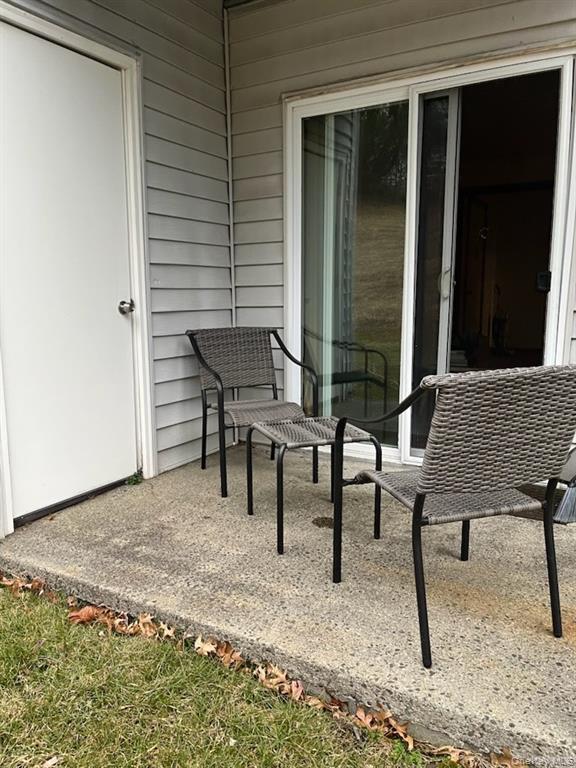 7 Ivy Court, Unit B Fishkill, NY 12524 - Photo 15 of 15 a view of a backyard with a table and chairs