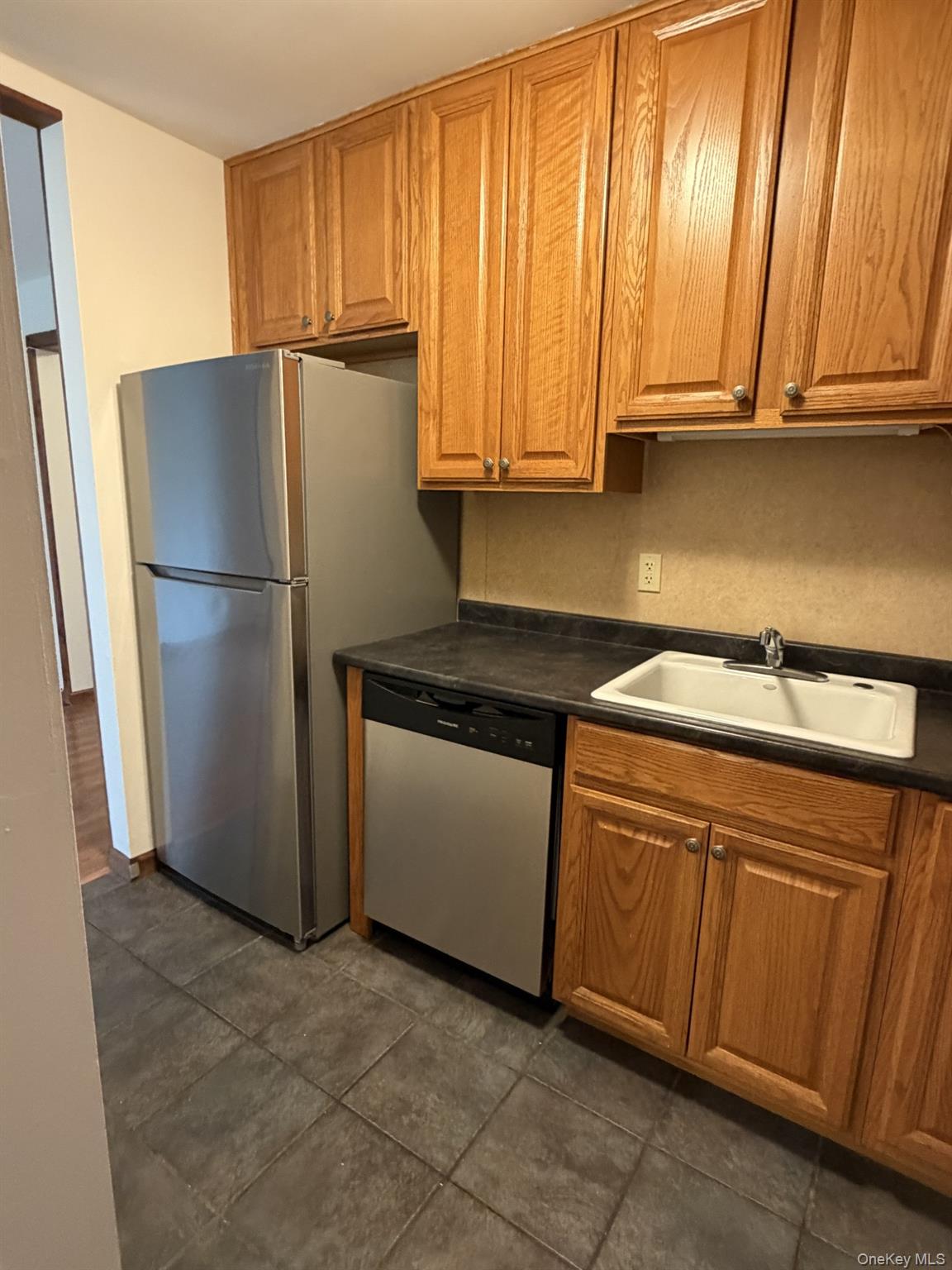 7 Ivy Court, Unit B Fishkill, NY 12524 - Photo 5 of 15 a kitchen with a refrigerator sink and cabinets