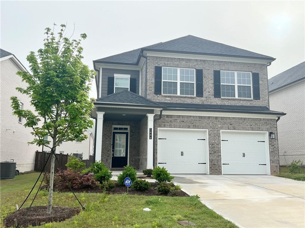 a front view of a house with a yard and garage