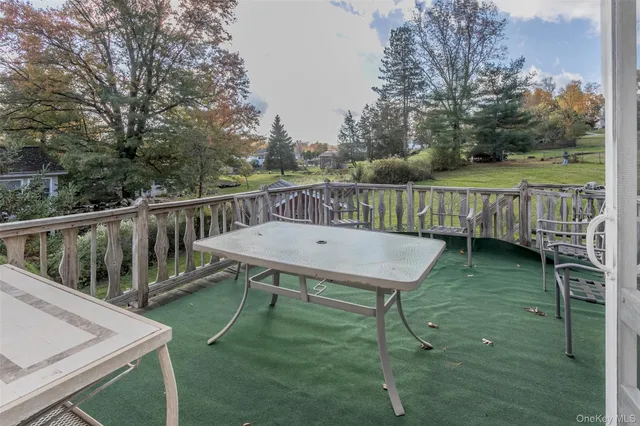 a view of a deck with a table and chairs