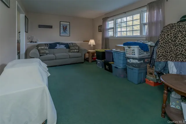 a living room with furniture a window and a flat screen tv