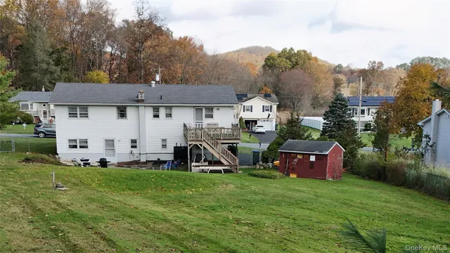 a view of a house with backyard sitting area and garden