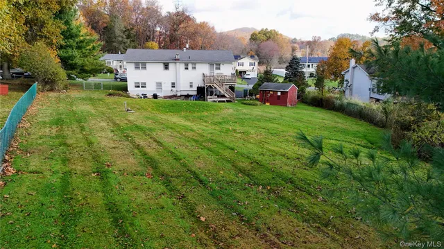 a view of a house with a yard and sitting area