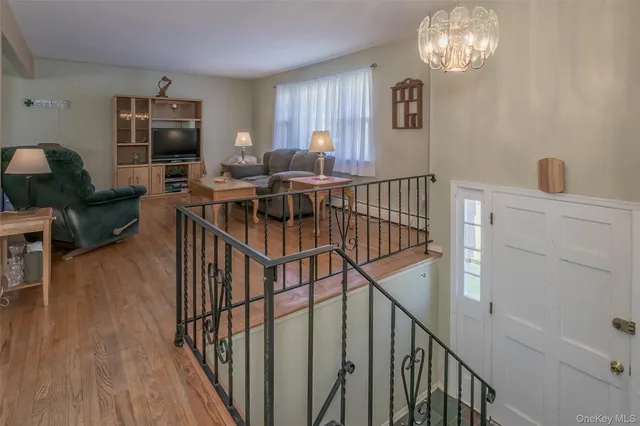 a view of entryway livingroom and hall with wooden floor