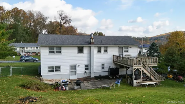 a view of a house with a yard and sitting area