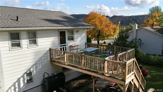 a view of a house with wooden deck