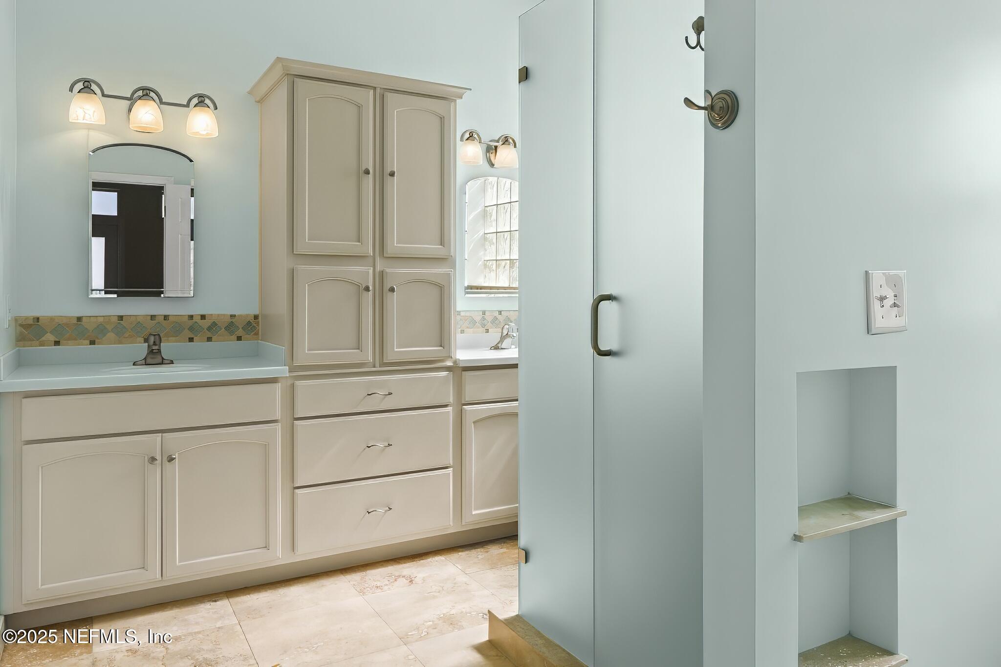 180 Kingston Drive St. Augustine, FL 32084 - Photo 21 of 55 a bathroom with a shower sink and mirror