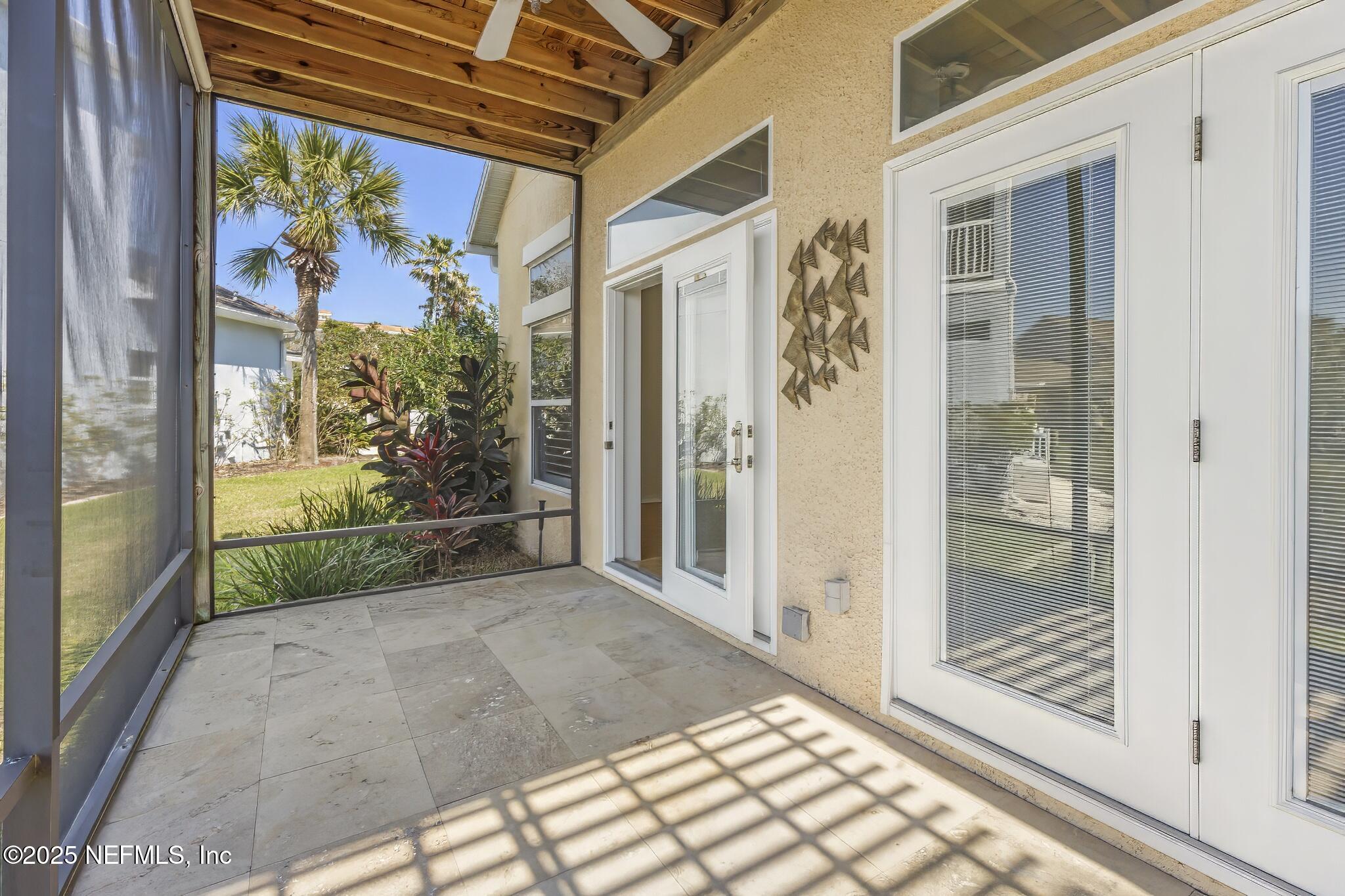 180 Kingston Drive St. Augustine, FL 32084 - Photo 26 of 55 a view of a porch with a floor to ceiling window and wooden floor