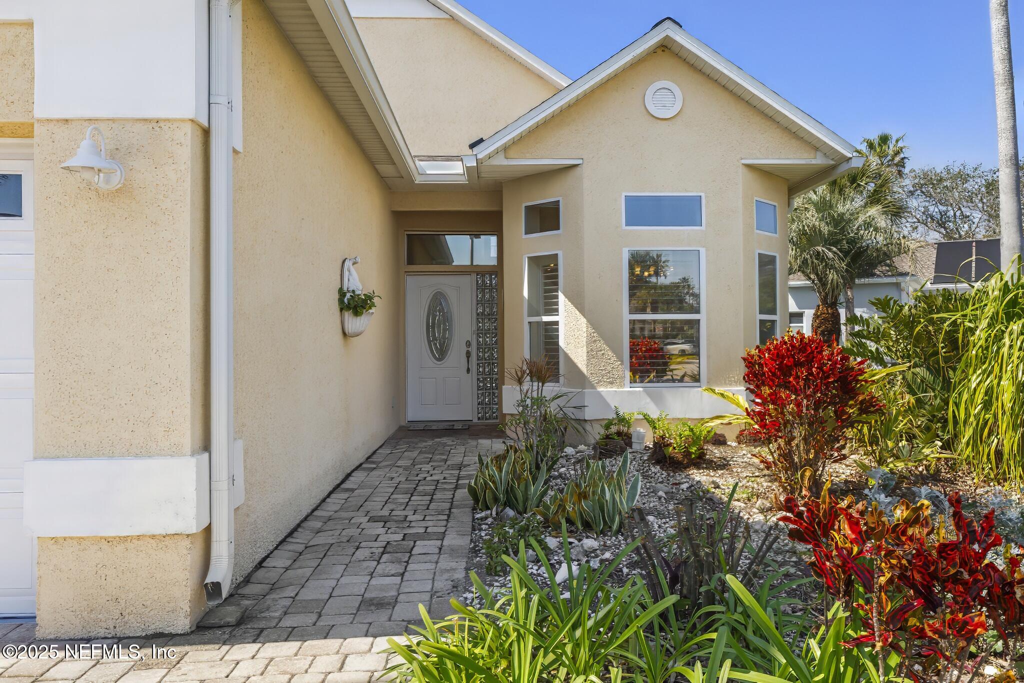 180 Kingston Drive St. Augustine, FL 32084 - Photo 3 of 55 a front view of a house with plants