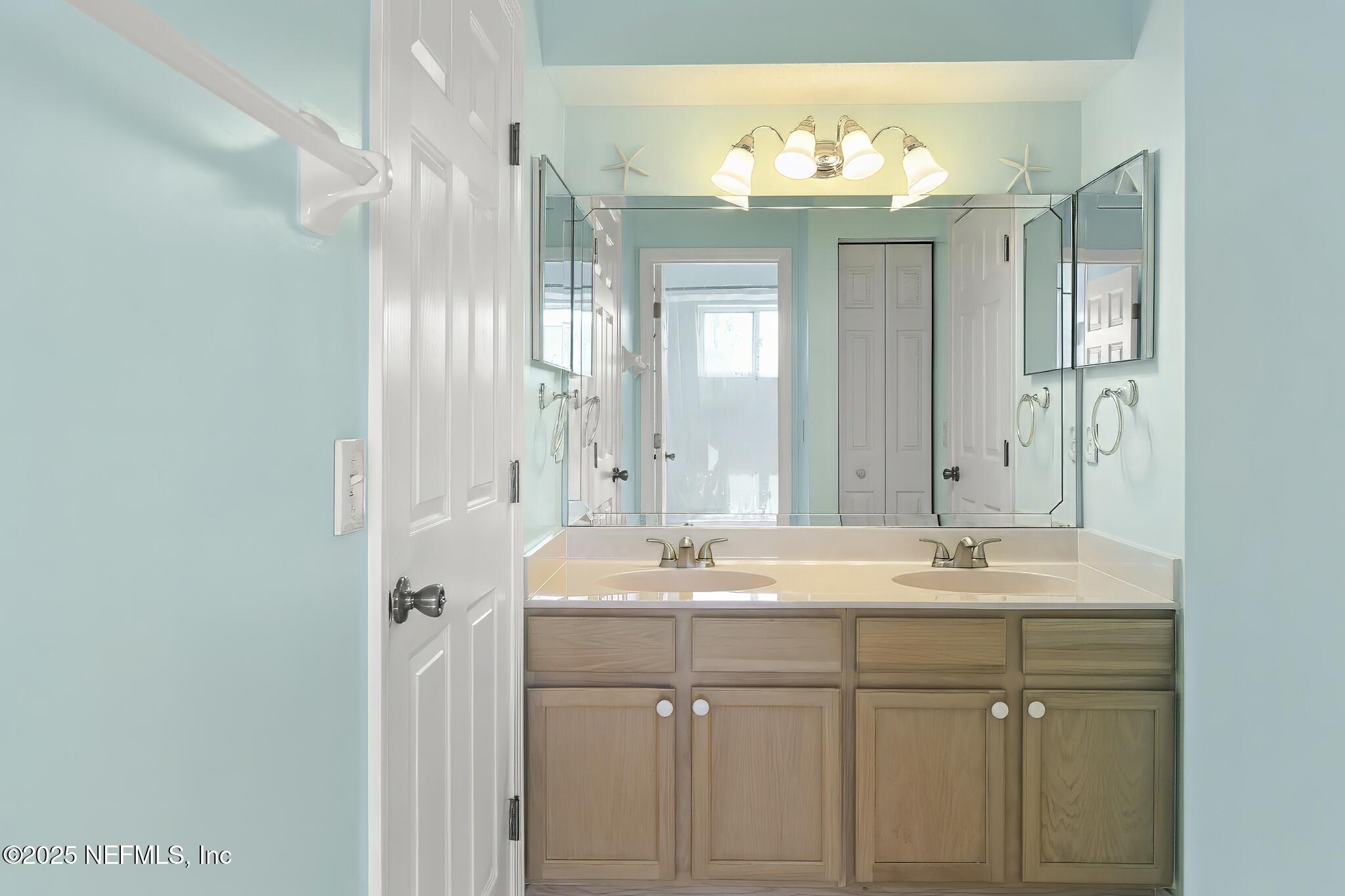180 Kingston Drive St. Augustine, FL 32084 - Photo 33 of 55 a bathroom with a sink vanity and a mirror